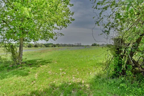 an aerial view of a house with a yard and lake view