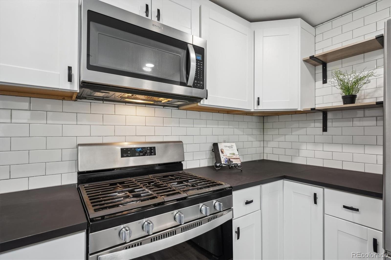 1852 South Decatur Street Denver, CO 80219 - Photo 12 of 45 a stove top oven sitting inside of a kitchen