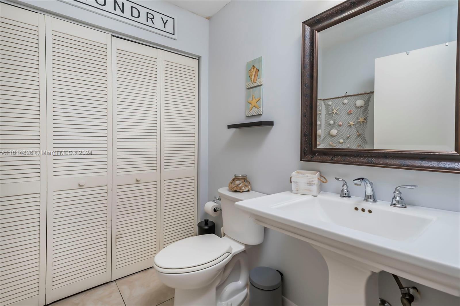 7643 Courtyard Run West Boca Raton, FL 33433 - Photo 13 of 35 a bathroom with a sink a toilet and mirror