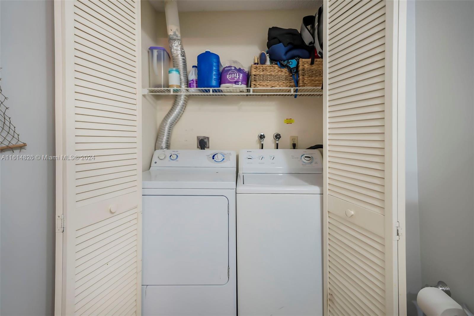 7643 Courtyard Run West Boca Raton, FL 33433 - Photo 14 of 35 a utility room with cabinets washer and dryer