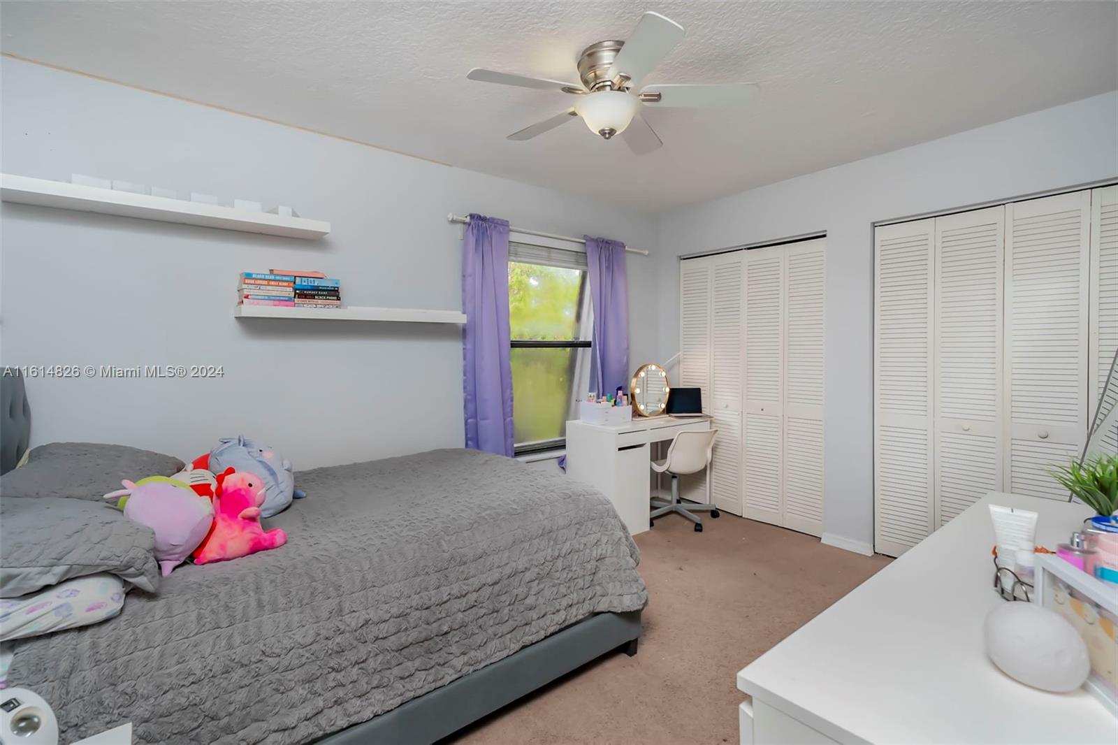 7643 Courtyard Run West Boca Raton, FL 33433 - Photo 15 of 35 a bedroom with a bed and a chandelier