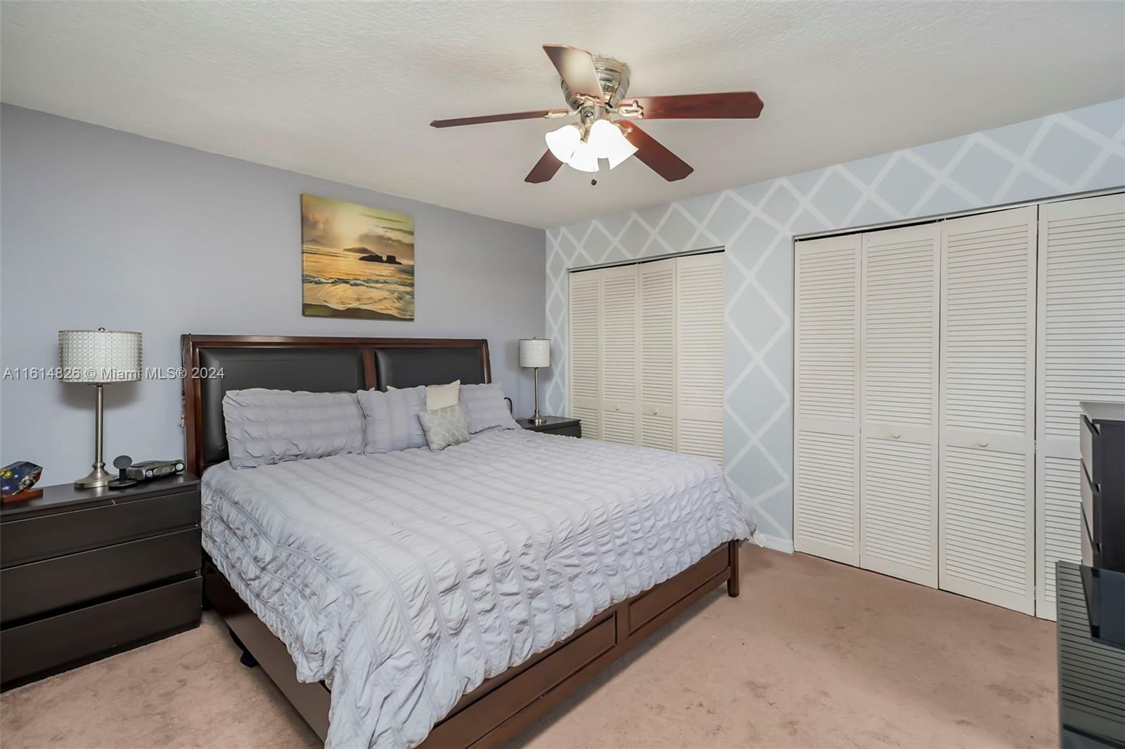 7643 Courtyard Run West Boca Raton, FL 33433 - Photo 17 of 35 a bedroom with a bed and a painting on the wall