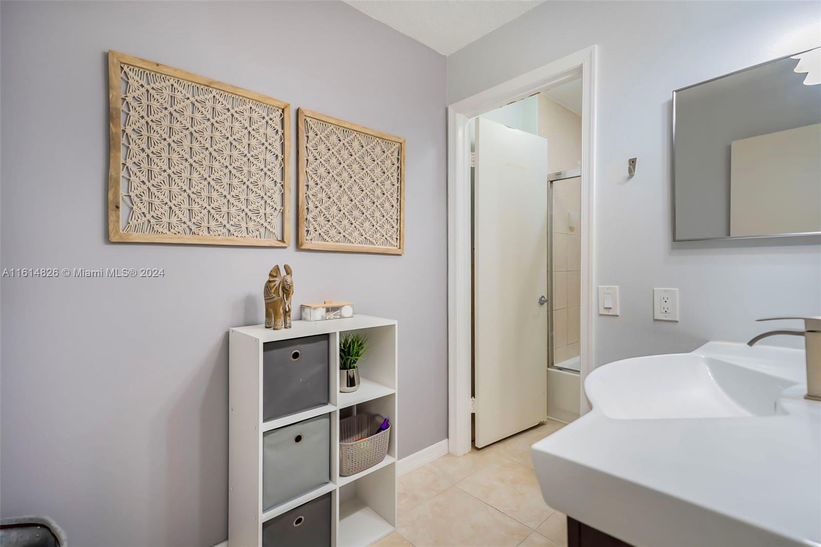 7643 Courtyard Run West Boca Raton, FL 33433 - Photo 19 of 35 a bathroom with a sink and a mirror