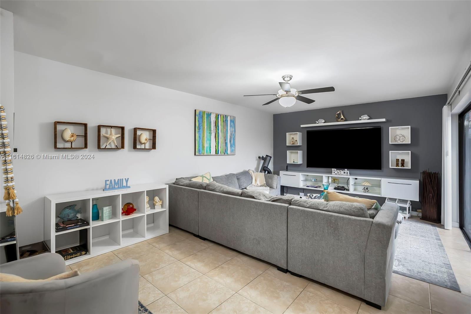 7643 Courtyard Run West Boca Raton, FL 33433 - Photo 2 of 35 a living room with furniture and a flat screen tv