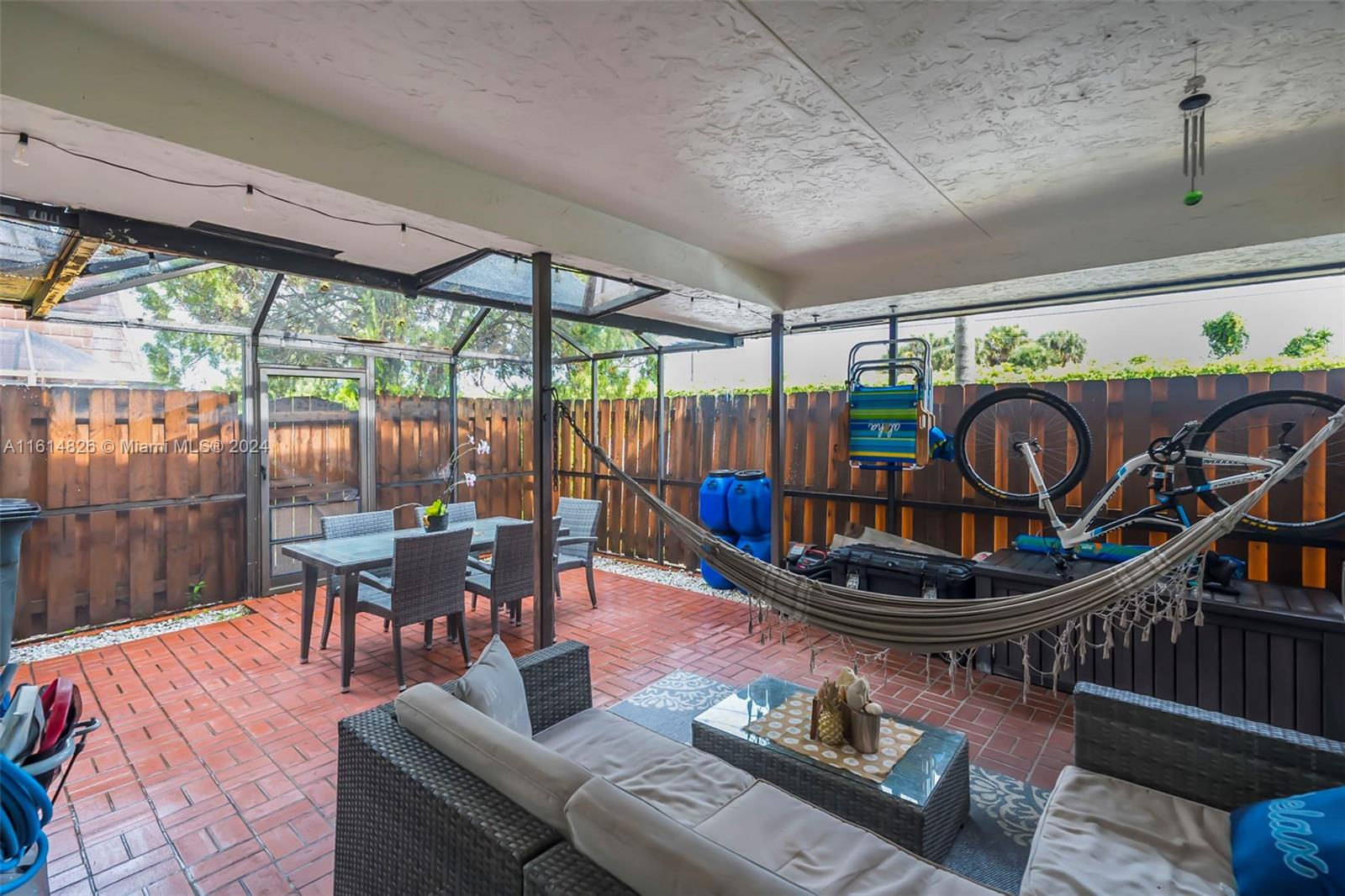 7643 Courtyard Run West Boca Raton, FL 33433 - Photo 23 of 35 a living room with furniture a table and a large window