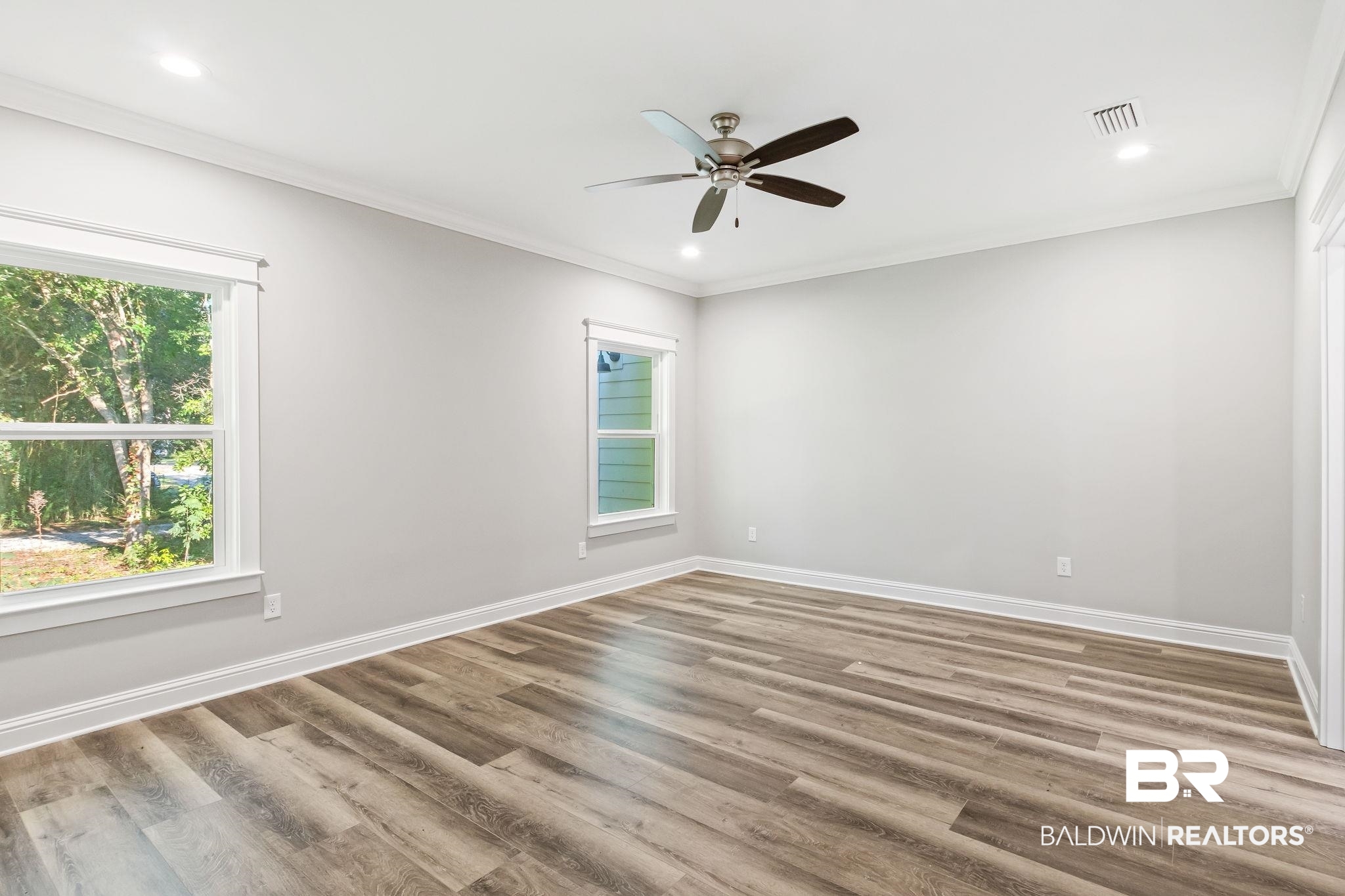12441 Reunion Place Foley, AL 36535 - Photo 13 of 31 Empty room with ceiling fan, hardwood / wood-style flooring, and ornamental molding