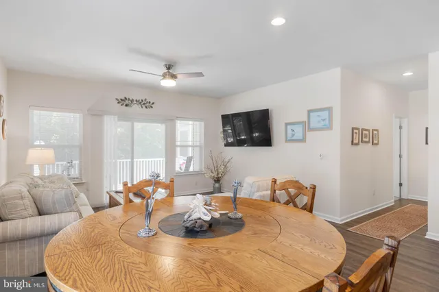 a living room with lots of furniture and kitchen view