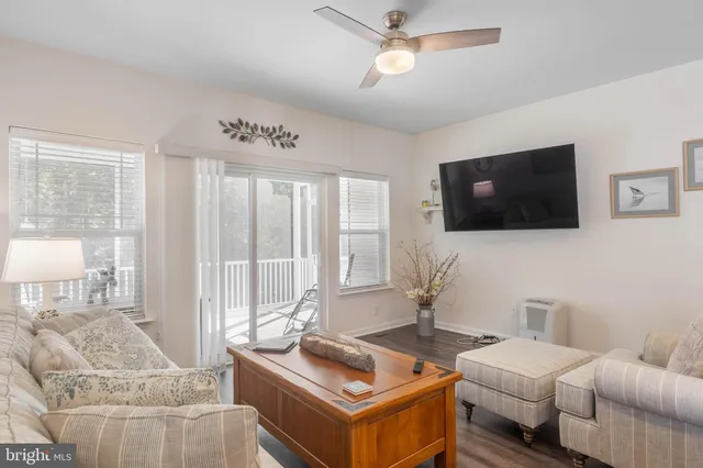 a bedroom with a bed closet and a flat tv screen