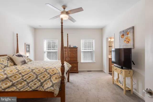 a room with a flat screen tv and a lamp