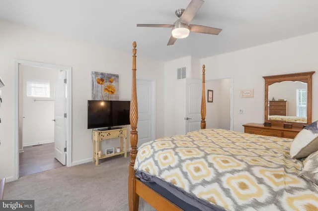 a bathroom with a sink a toilet a mirror a vanity and shower