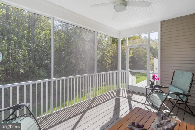 a view of a dining room with furniture and a large window
