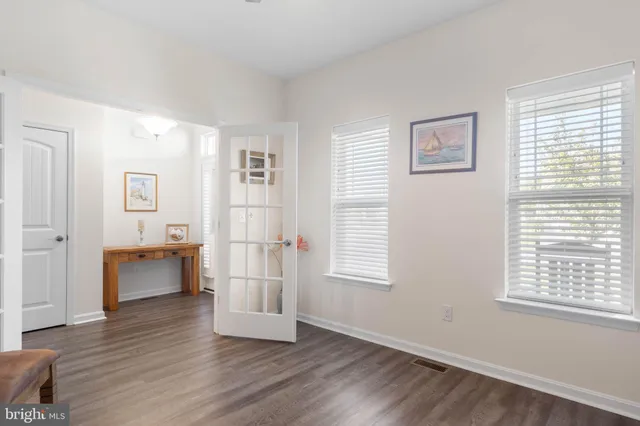 a large white kitchen with stainless steel appliances