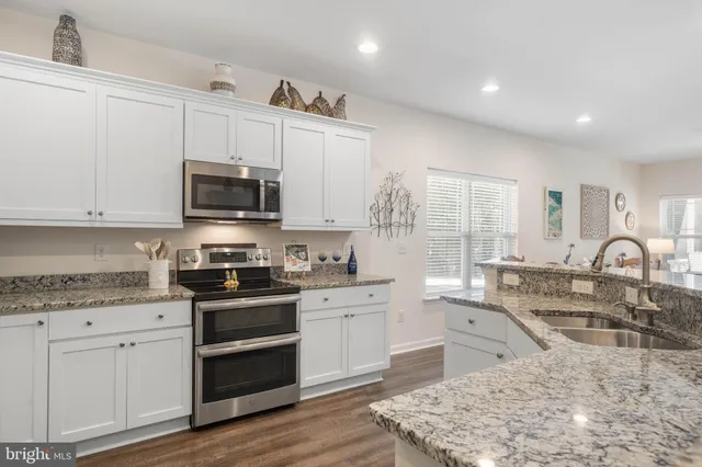 a bed room with a bed a couch and a flat screen tv