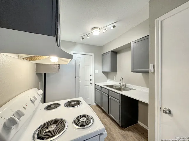 a utility room with sink dryer and washer