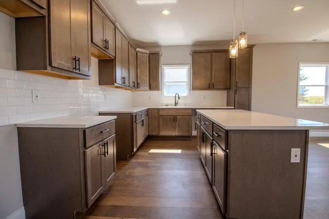 a kitchen with stainless steel appliances a sink stove and cabinets