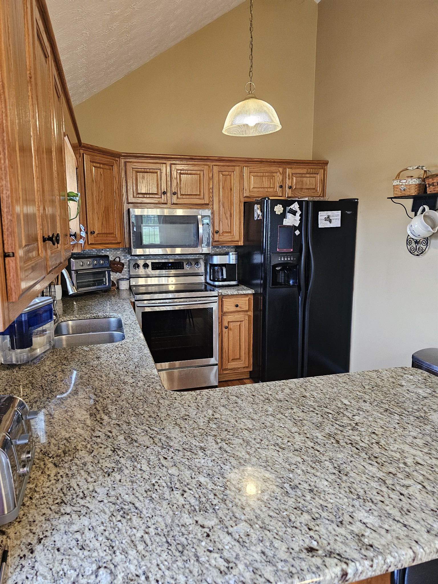 285 Browns Road Lafayette, TN 37083 - Photo 4 of 30 a kitchen with stainless steel appliances granite countertop a stove top oven a sink a counter space and cabinets