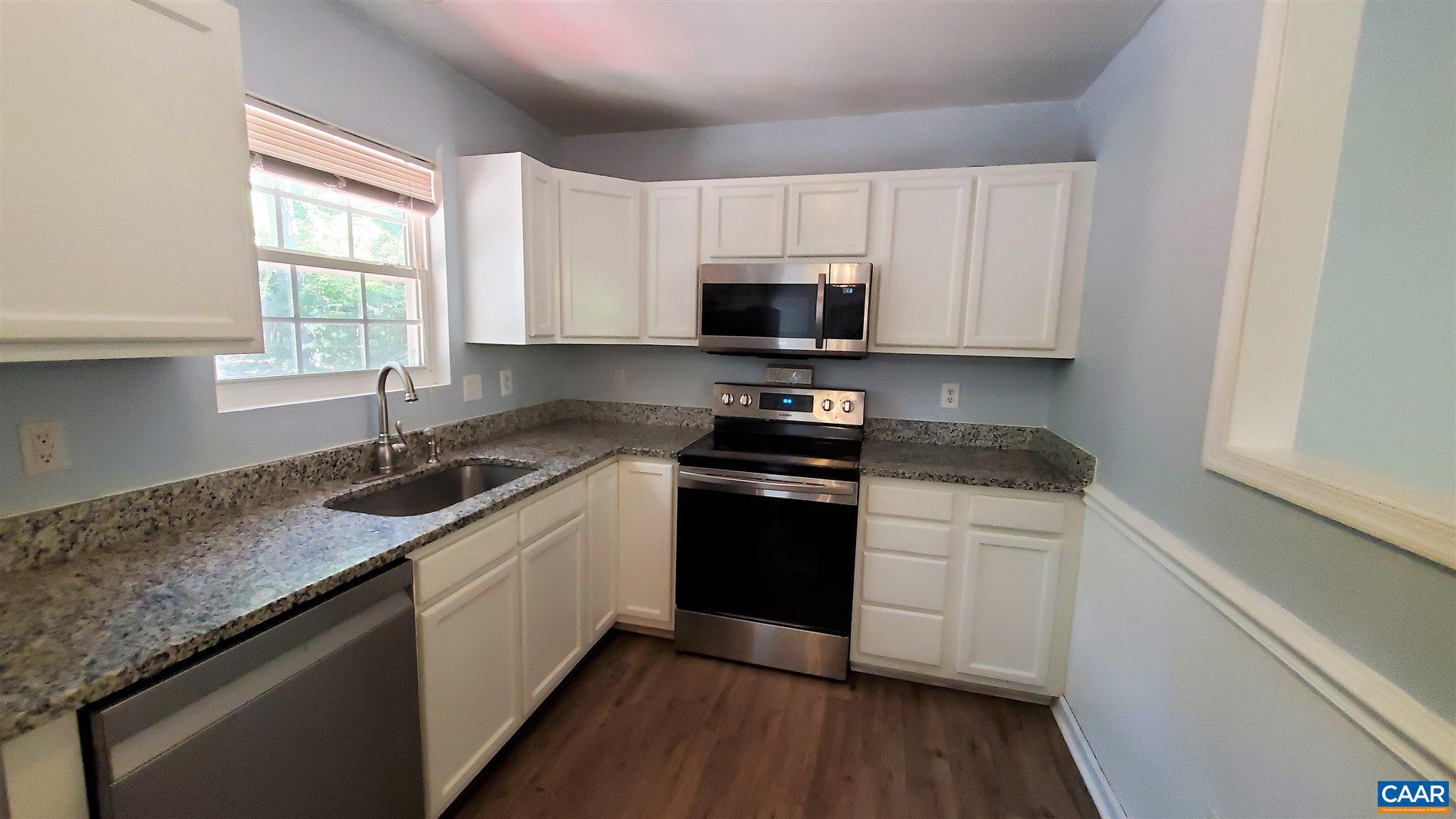 26 Xebec Road Palmyra, VA 22963 - Photo 6 of 21 a kitchen with granite countertop white cabinets appliances a window and a sink