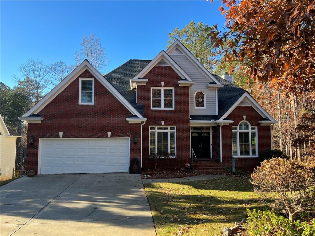 6438 Old Shadburn Ferry Road Buford, GA 30518 - Photo 1 of 1 a front view of a house with a yard