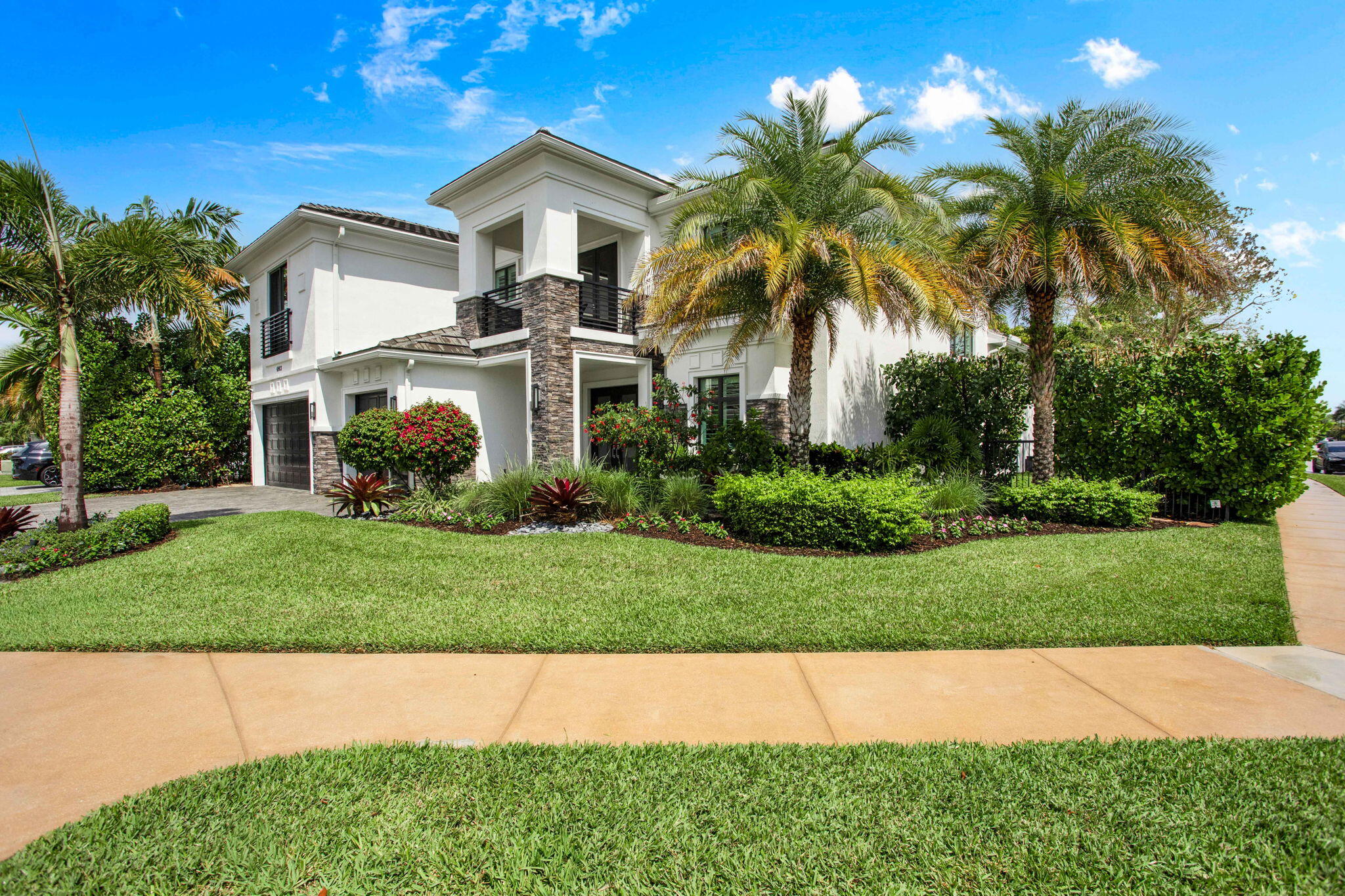6903 Northwest 28th Avenue Boca Raton, FL 33496 - Photo 7 of 69 a front view of a house with a garden