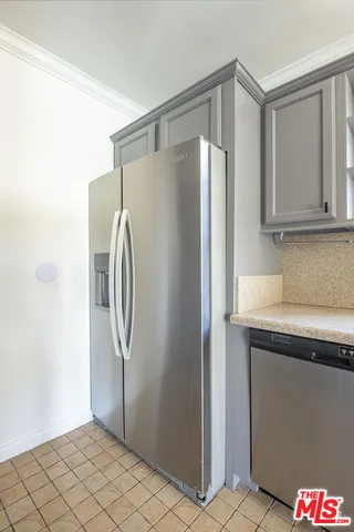 a kitchen with metallic refrigerator freezer and a dishwasher