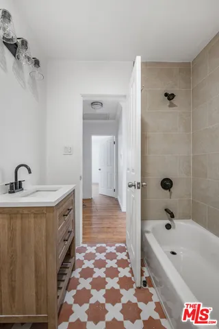 a bathroom with a bathtub sink and a shower