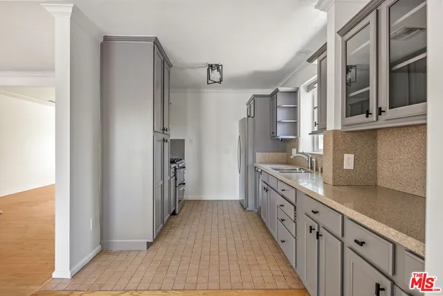 a kitchen with stainless steel appliances granite countertop a refrigerator and a sink