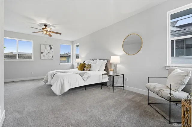 a bed room with a bed and a chair