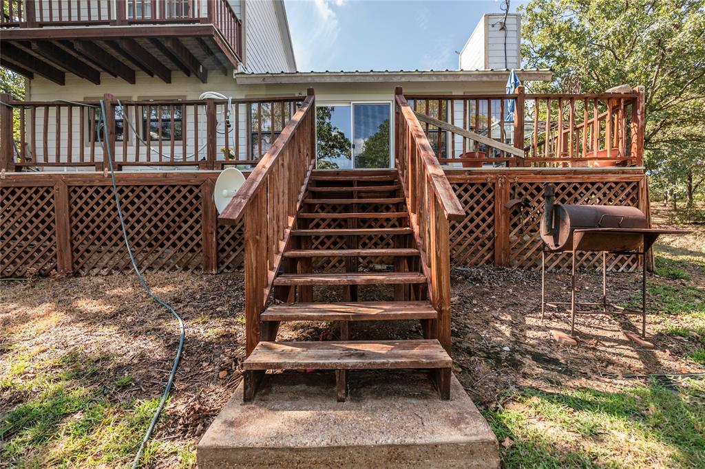 698 Storey Road Nocona, TX 76255 - Photo 7 of 34 Wooden terrace with stairway
