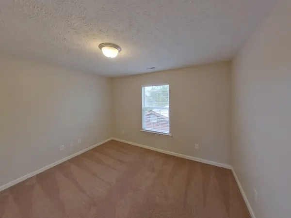 an empty room with a empty space and windows