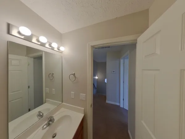 a bathroom with a sink a shower and a mirror