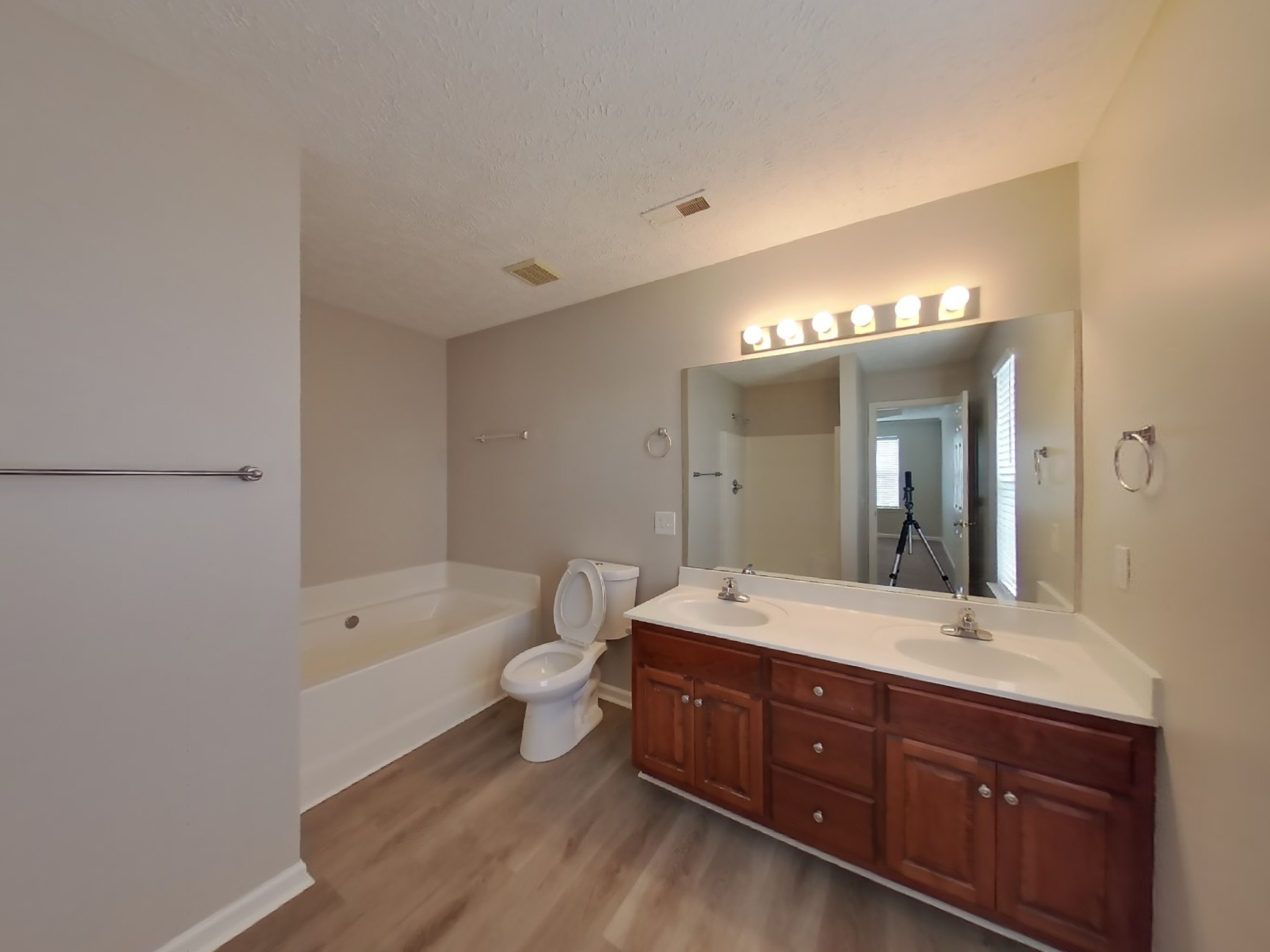 4812 Hammock Drive Murfreesboro, TN 37128 - Photo 9 of 17 a spacious bathroom with a double vanity sink a large mirror and a bathtub
