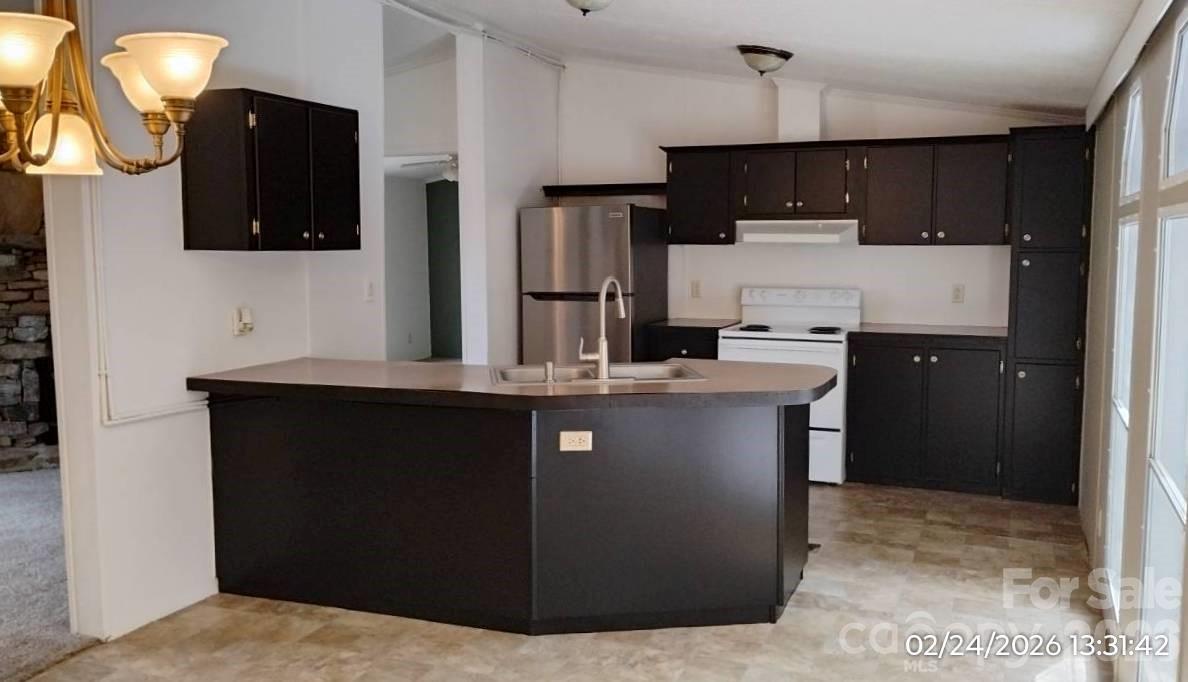 115 Paradise Mountain Road Canton, NC 28716 - Photo 5 of 12 a kitchen with stainless steel appliances granite countertop a refrigerator a sink and a stove