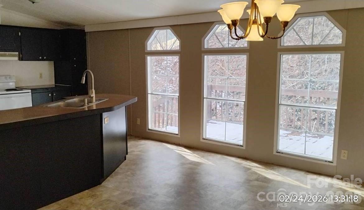 115 Paradise Mountain Road Canton, NC 28716 - Photo 7 of 12 a view of a kitchen with a sink cabinet and a window