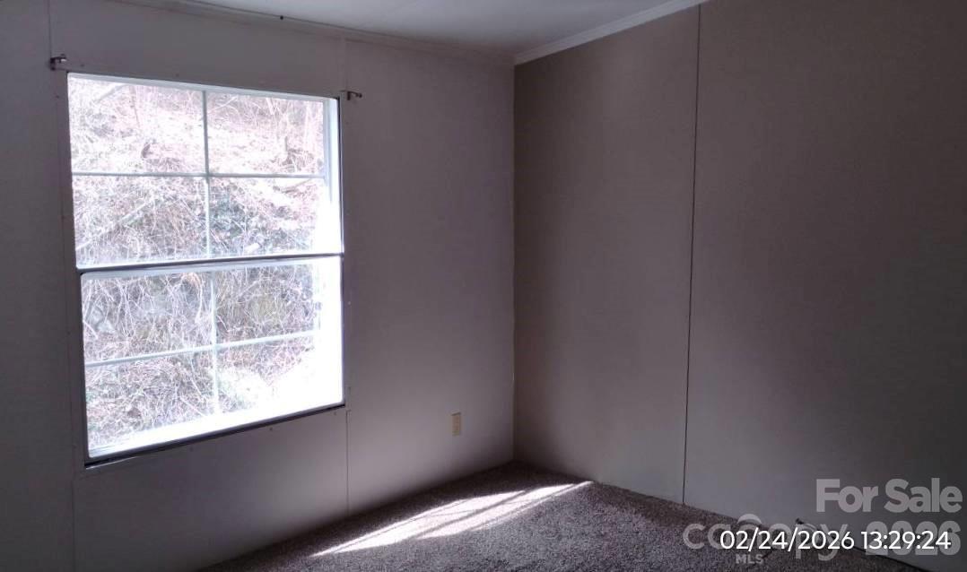 115 Paradise Mountain Road Canton, NC 28716 - Photo 10 of 12 a view of an empty room with a window