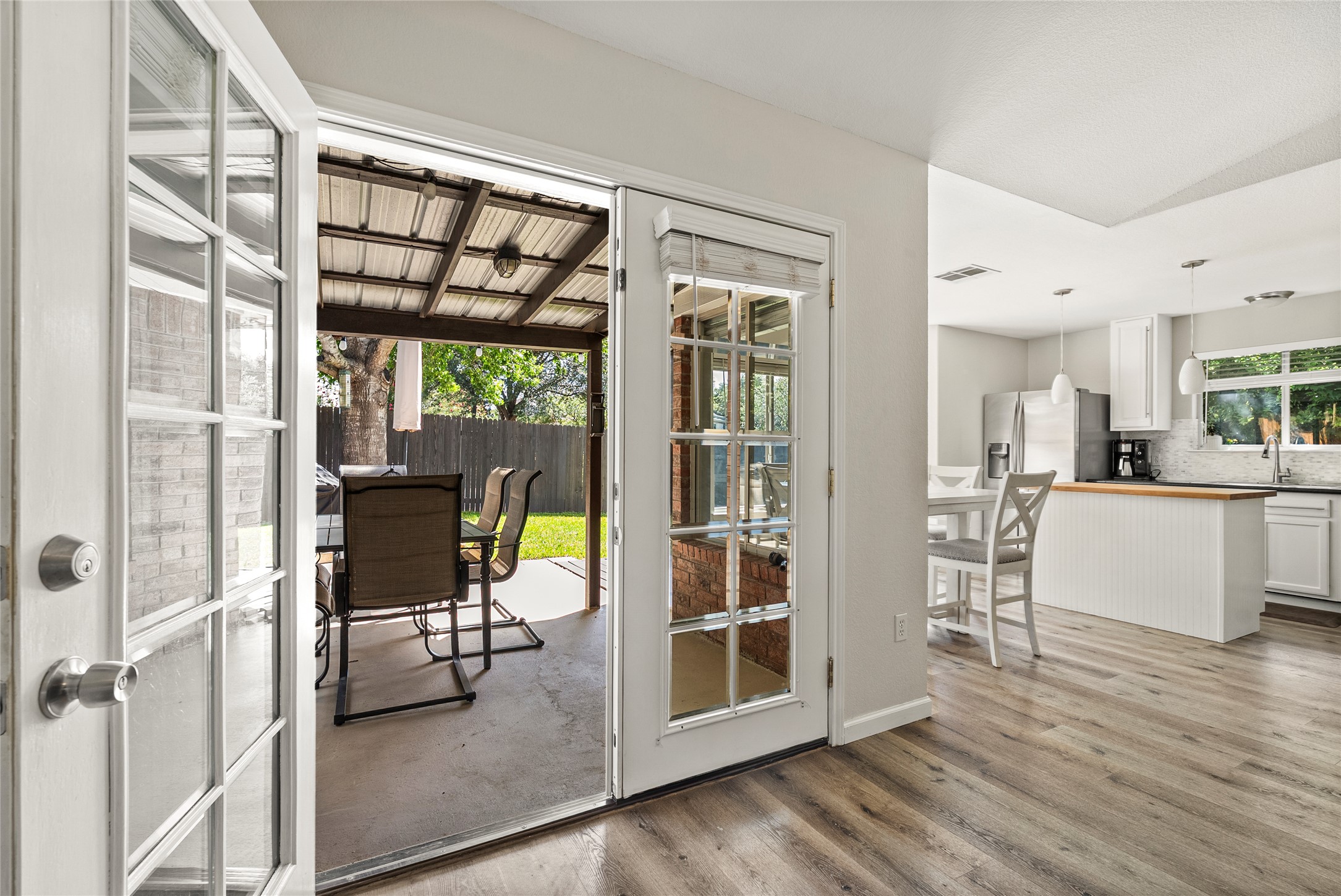 9024 Heiden Lane Austin, TX 78749 - Photo 28 of 33 Doors open directly from the main living spaces out onto the back patio, blending your indoor living seamlessly with the outdoor patio