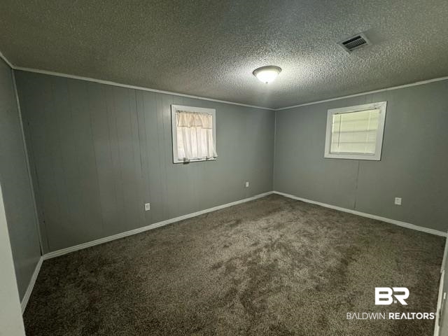 502 Forest Street Mobile, AL 36611 - Photo 8 of 10 Carpeted empty room featuring a textured ceiling