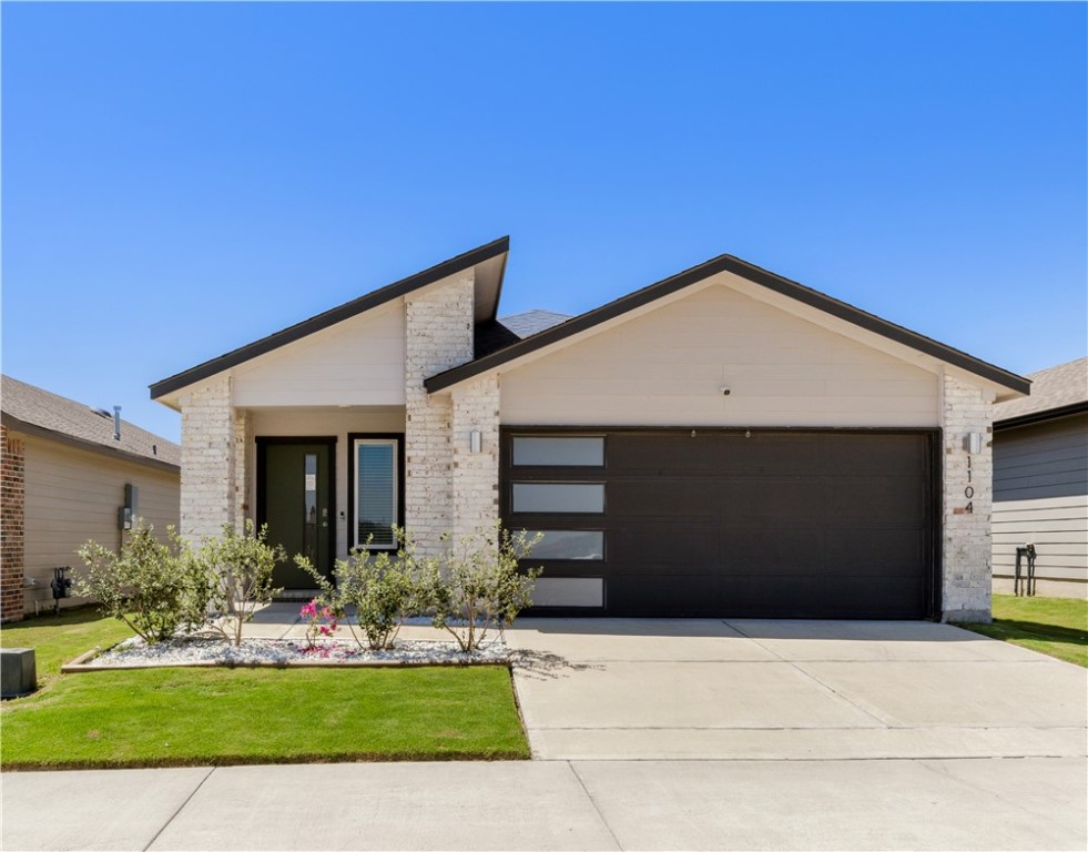 View of front of property featuring concrete drive