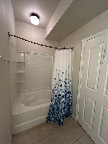a bathroom with a shower curtain and a bathtub
