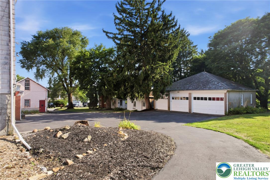 4682 Steuben Road Bethlehem, PA 18020 - Photo 49 of 79 A well-maintained paved driveway leads to a detached garage, offering ample parking and storage.