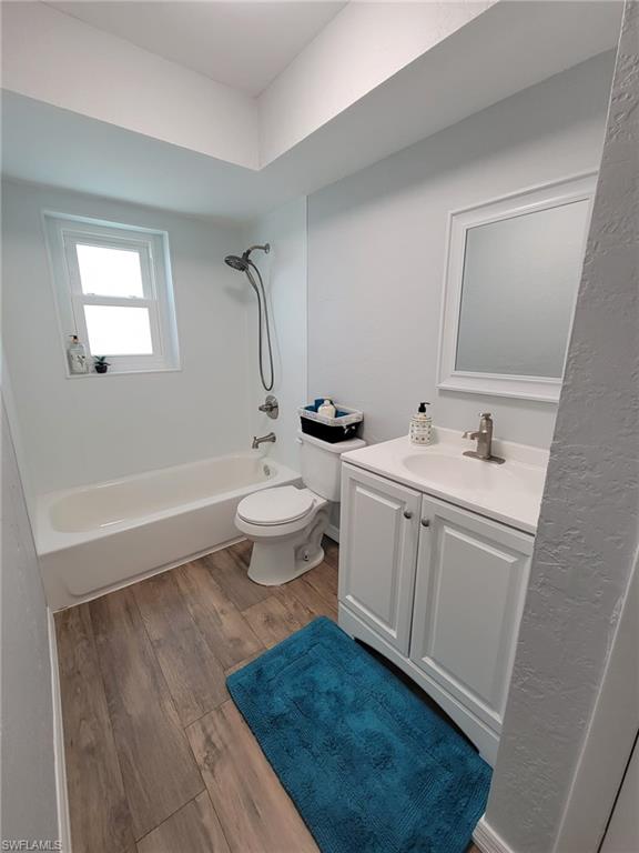 18613 Sebring Road Fort Myers, FL 33967 - Photo 8 of 12 a bathroom with a sink toilet a mirror and shower