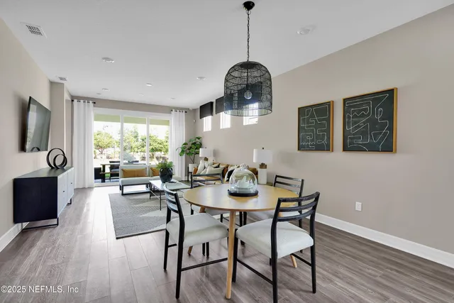 a dining room with furniture and wooden floor