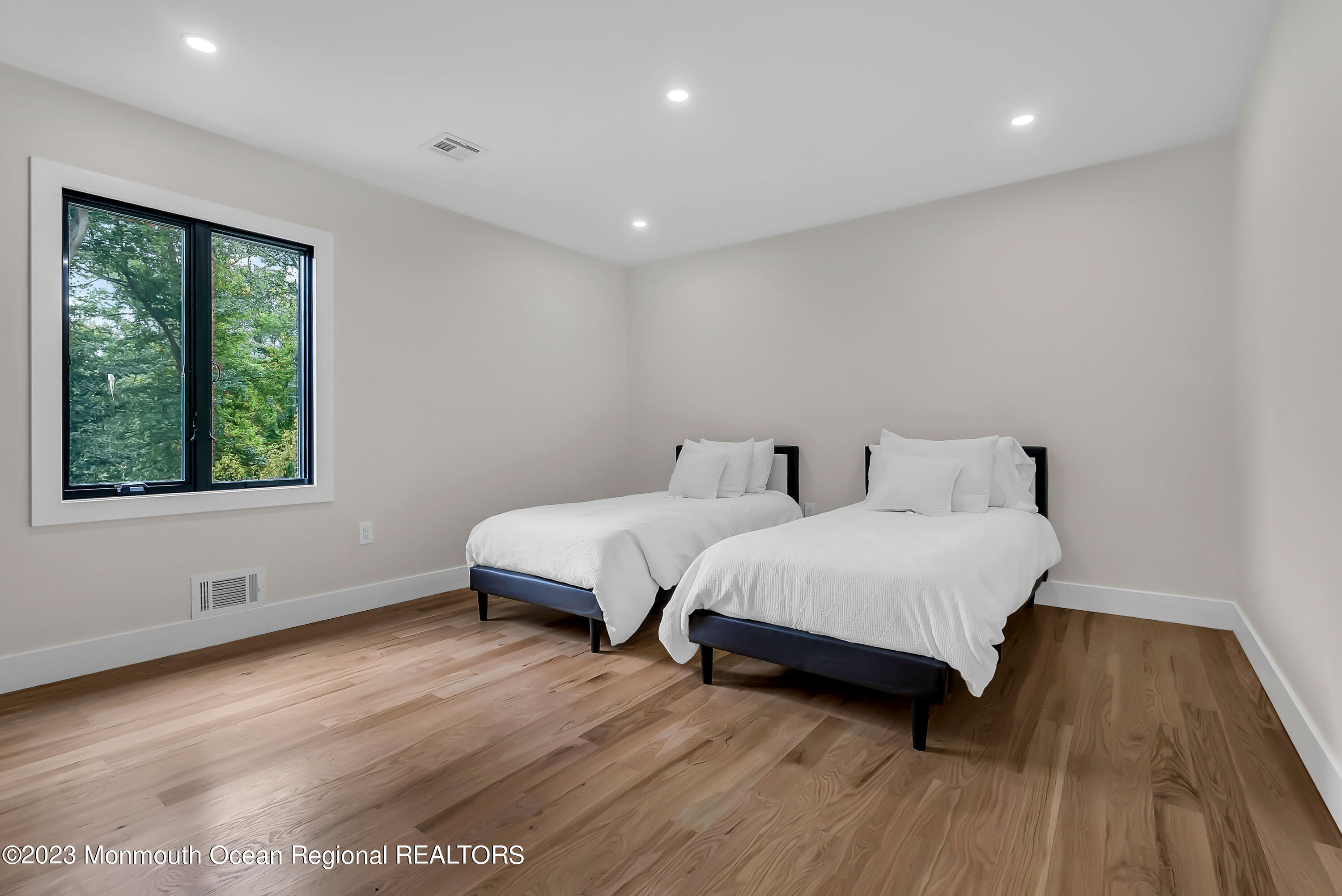 265 Whalepond Road Oakhurst, NJ 07755 - Photo 15 of 34 a spacious bedroom with a bed and wooden floor