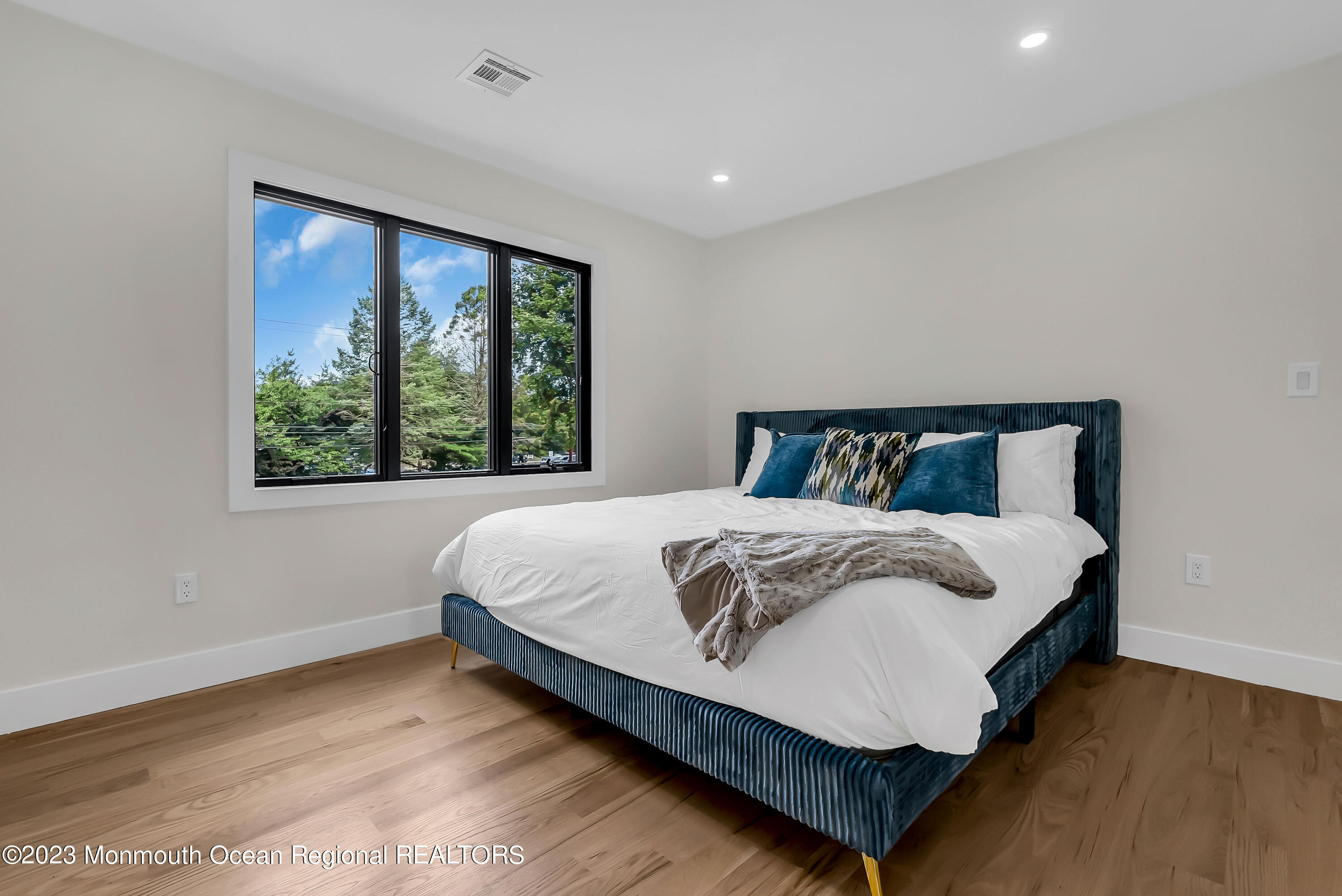 265 Whalepond Road Oakhurst, NJ 07755 - Photo 19 of 34 a large bed sitting in a bedroom next to a window