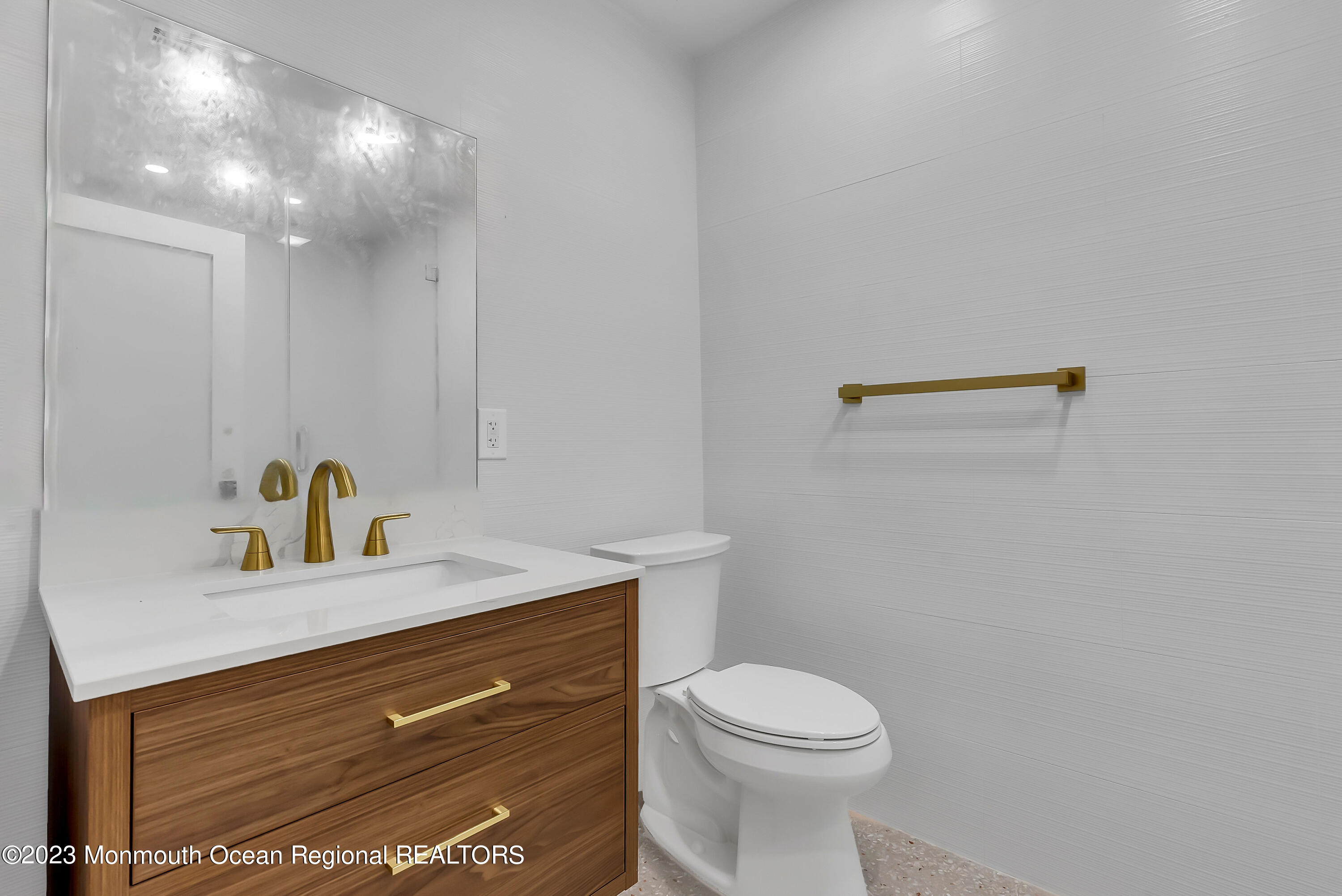 265 Whalepond Road Oakhurst, NJ 07755 - Photo 21 of 34 a bathroom with a sink a toilet and a mirror