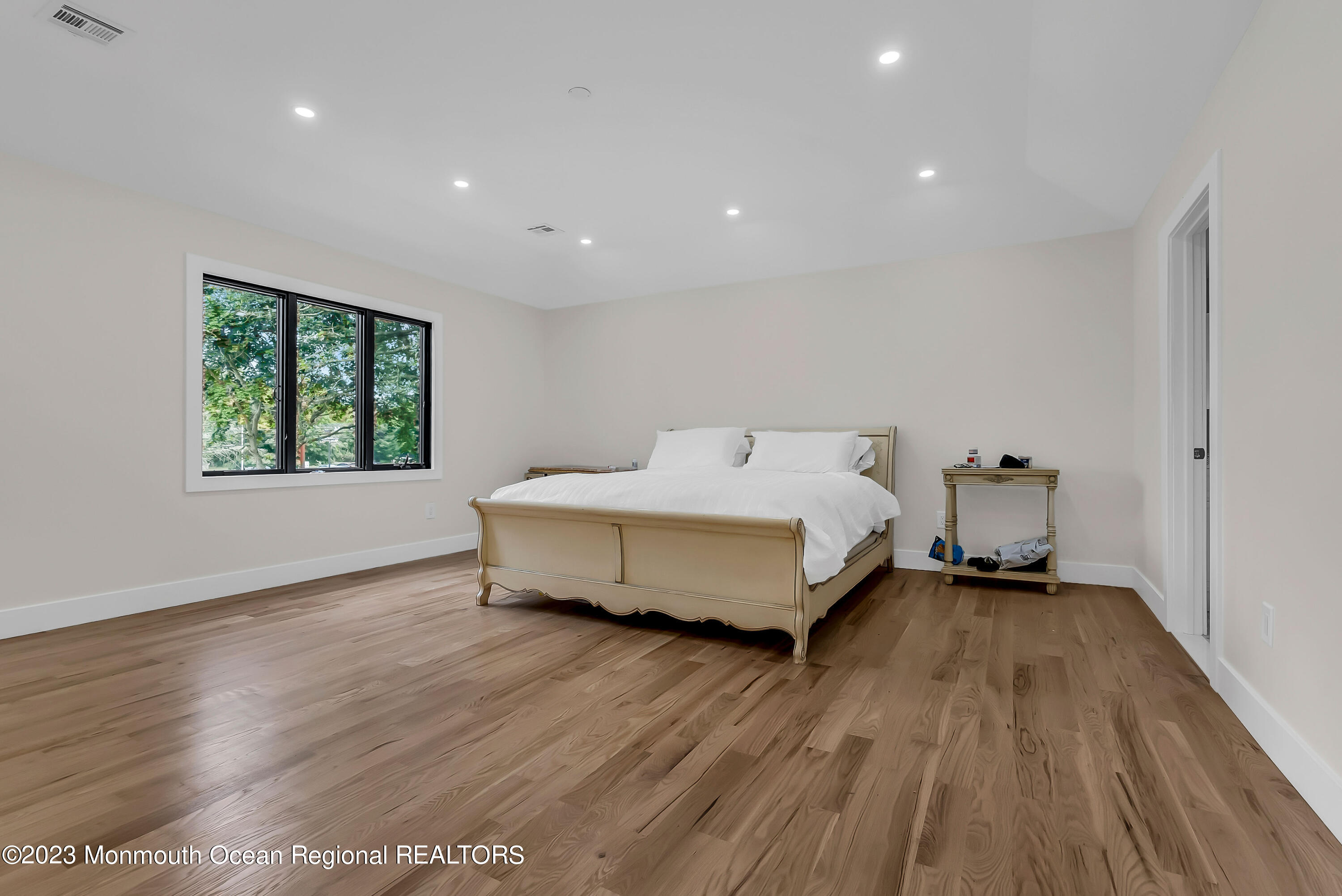 265 Whalepond Road Oakhurst, NJ 07755 - Photo 23 of 34 a spacious bedroom with a bed and a window