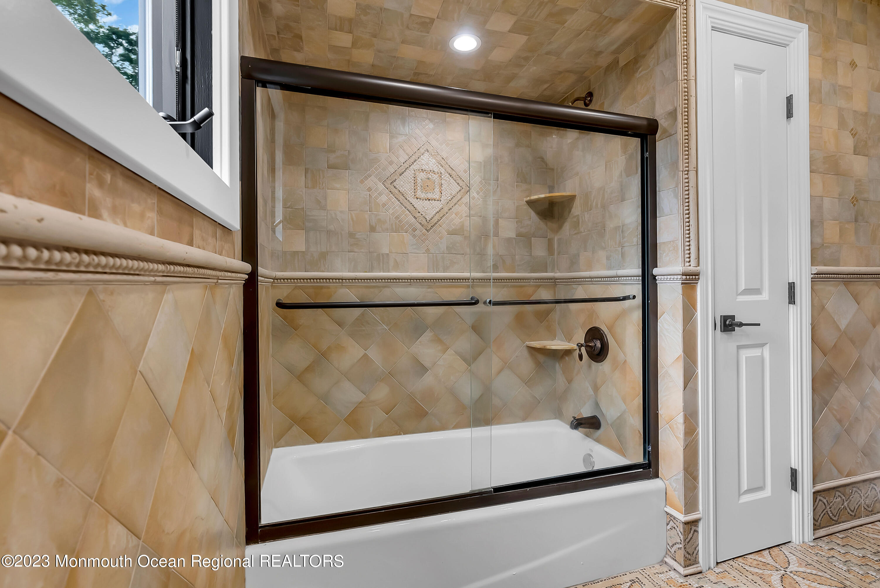 265 Whalepond Road Oakhurst, NJ 07755 - Photo 27 of 34 a bathroom with a glass door shower and mirror