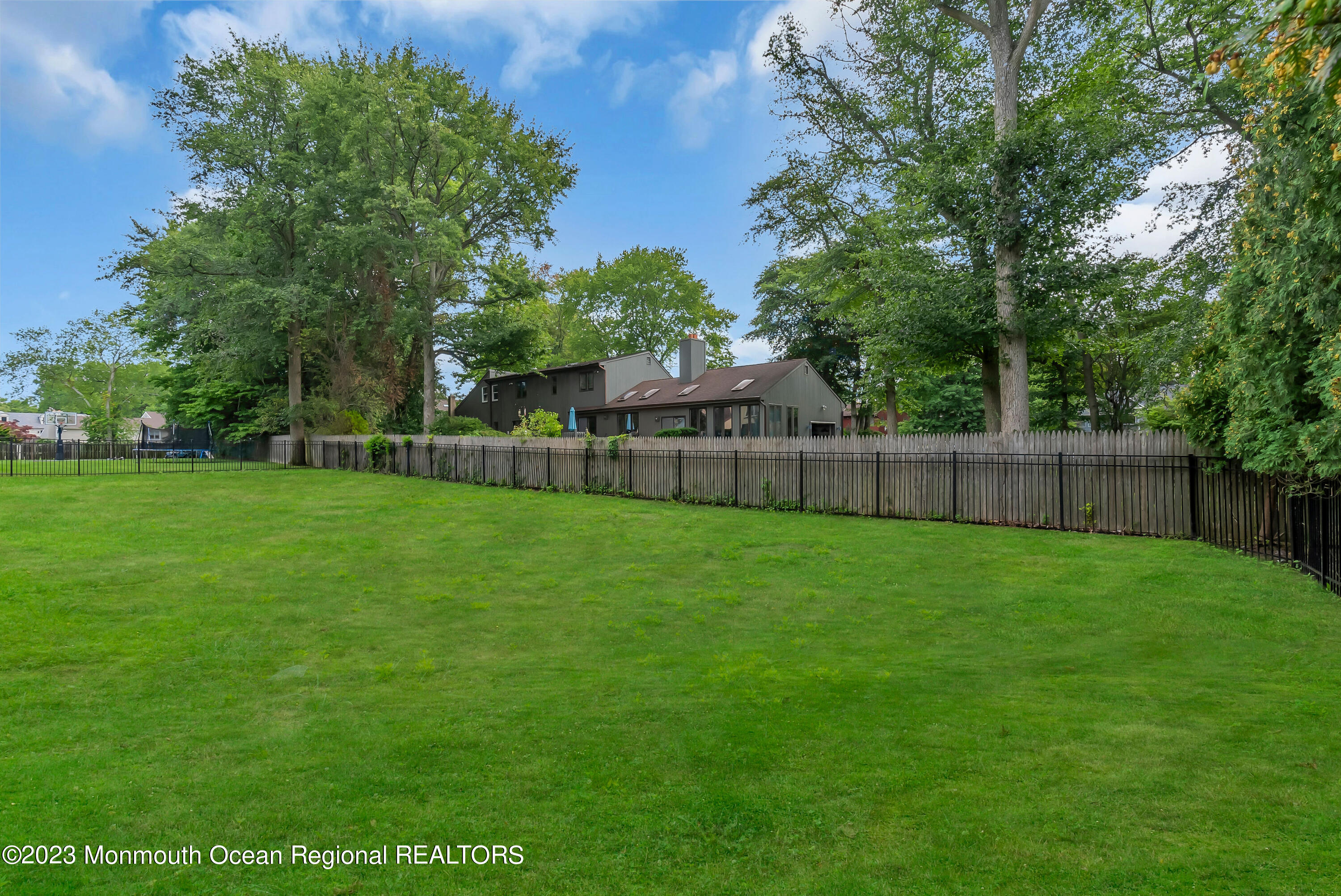 265 Whalepond Road Oakhurst, NJ 07755 - Photo 30 of 34 a view of a backyard with a garden and trees
