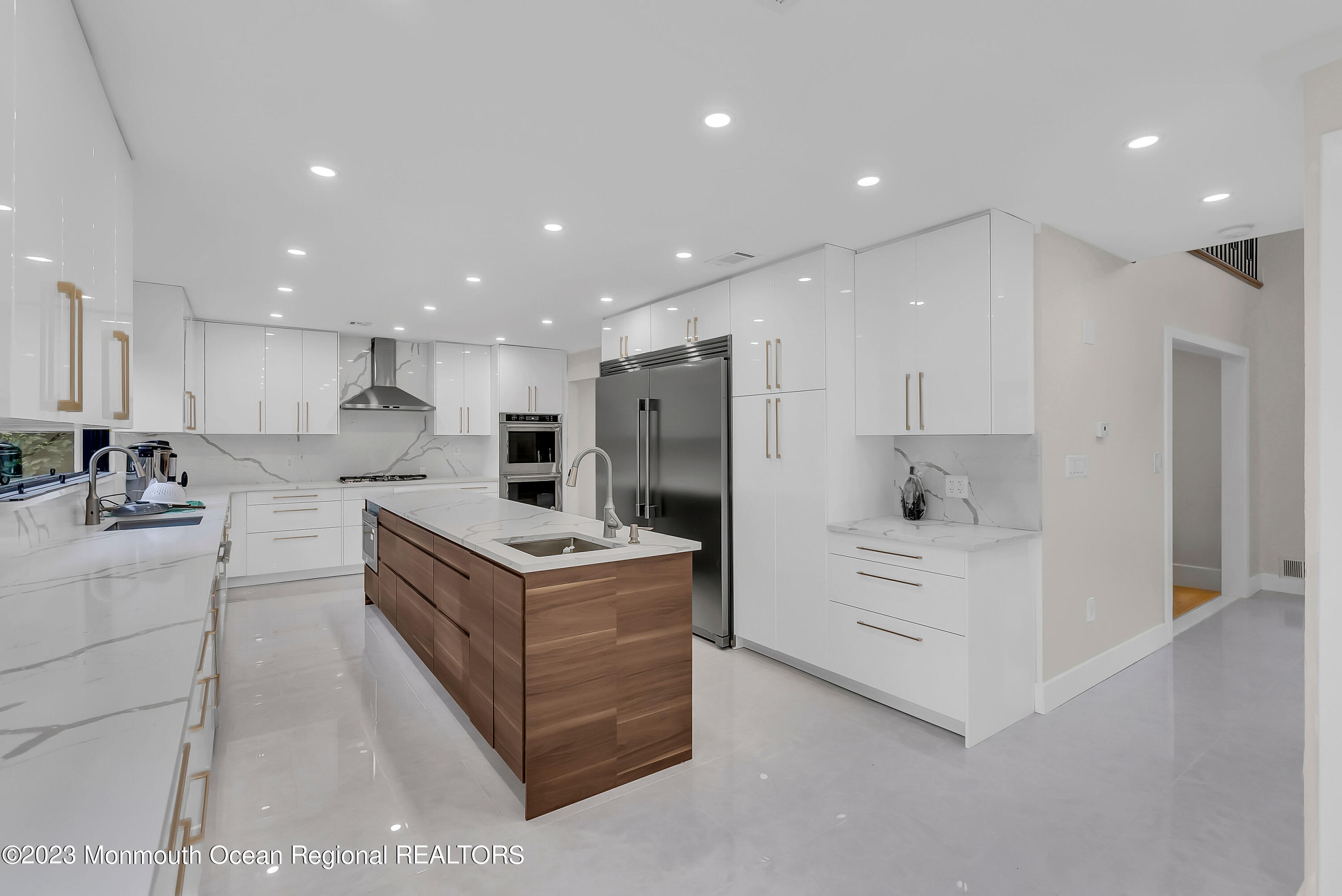 265 Whalepond Road Oakhurst, NJ 07755 - Photo 6 of 34 a kitchen with stainless steel appliances kitchen island sink and refrigerator