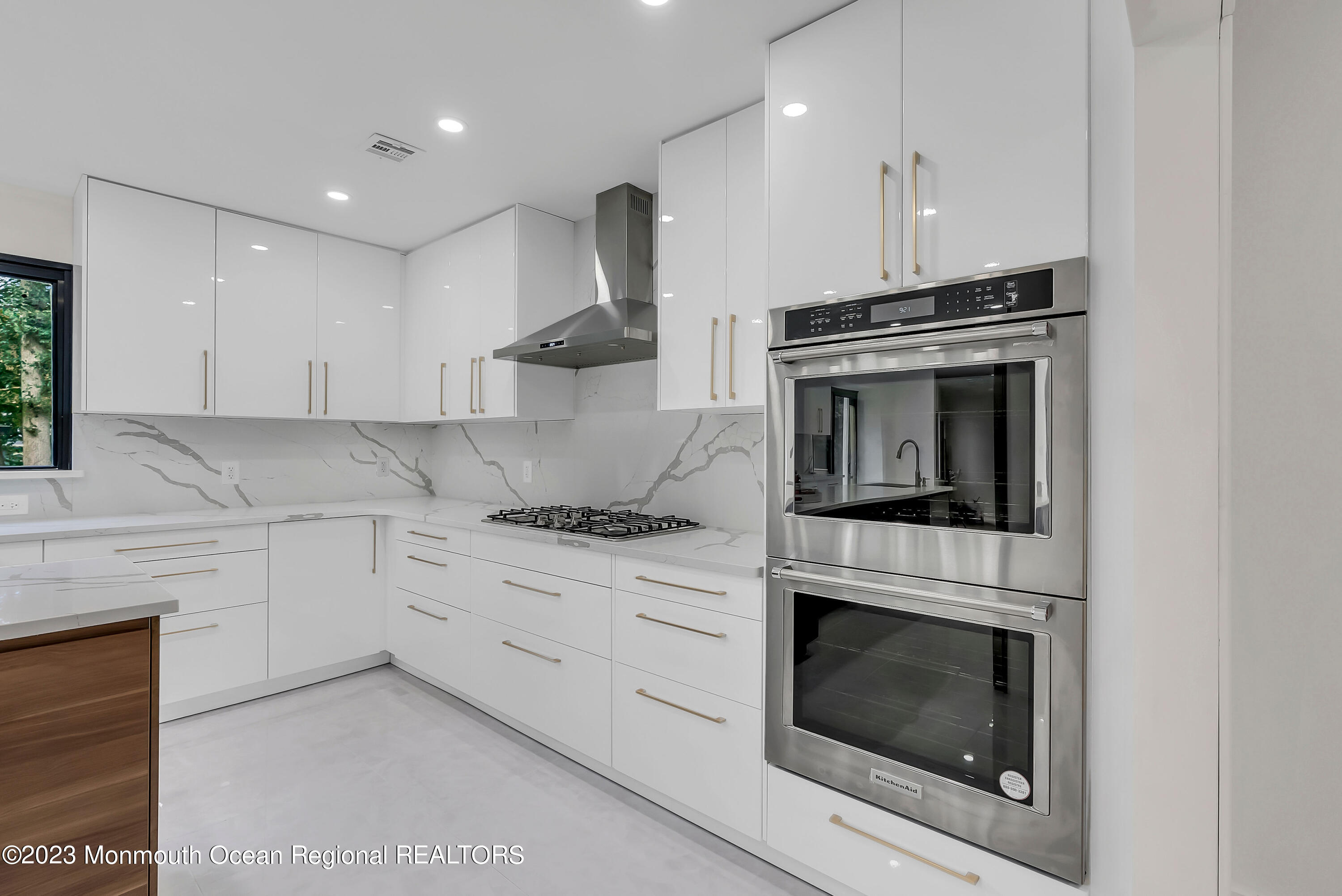 265 Whalepond Road Oakhurst, NJ 07755 - Photo 7 of 34 a kitchen with cabinets stainless steel appliances and a sink