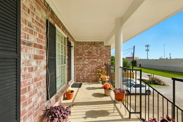 a view of a balcony with wooden floor